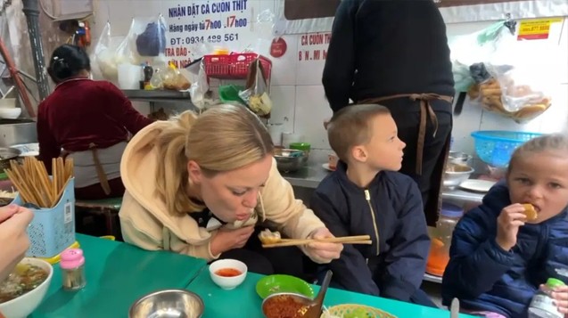 Enjoying street food together at a stall in Hanoi